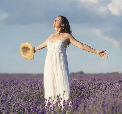 woman standing in a field of purple flowers