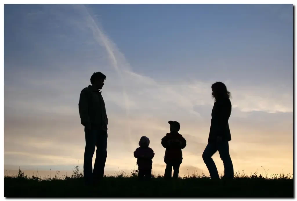 mother and father with two young boys looking at the sky