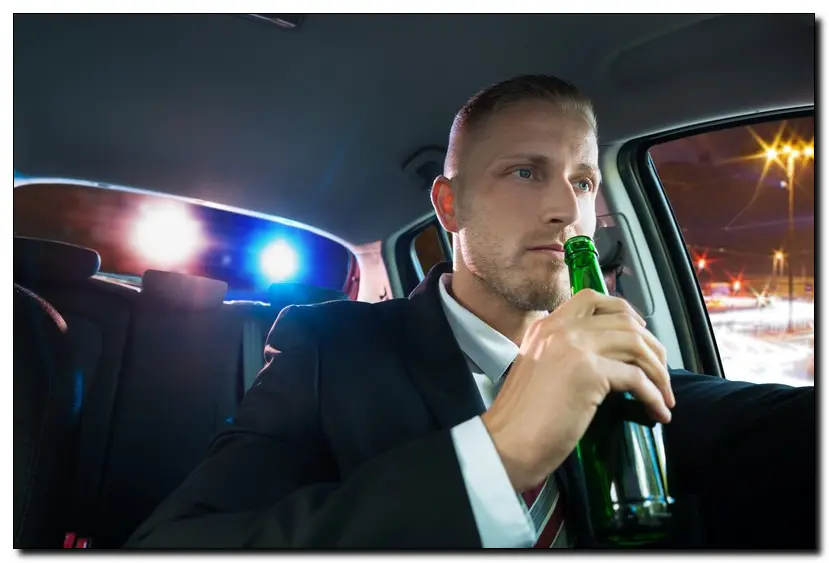 Man drinking and driving and being pulled over by the police